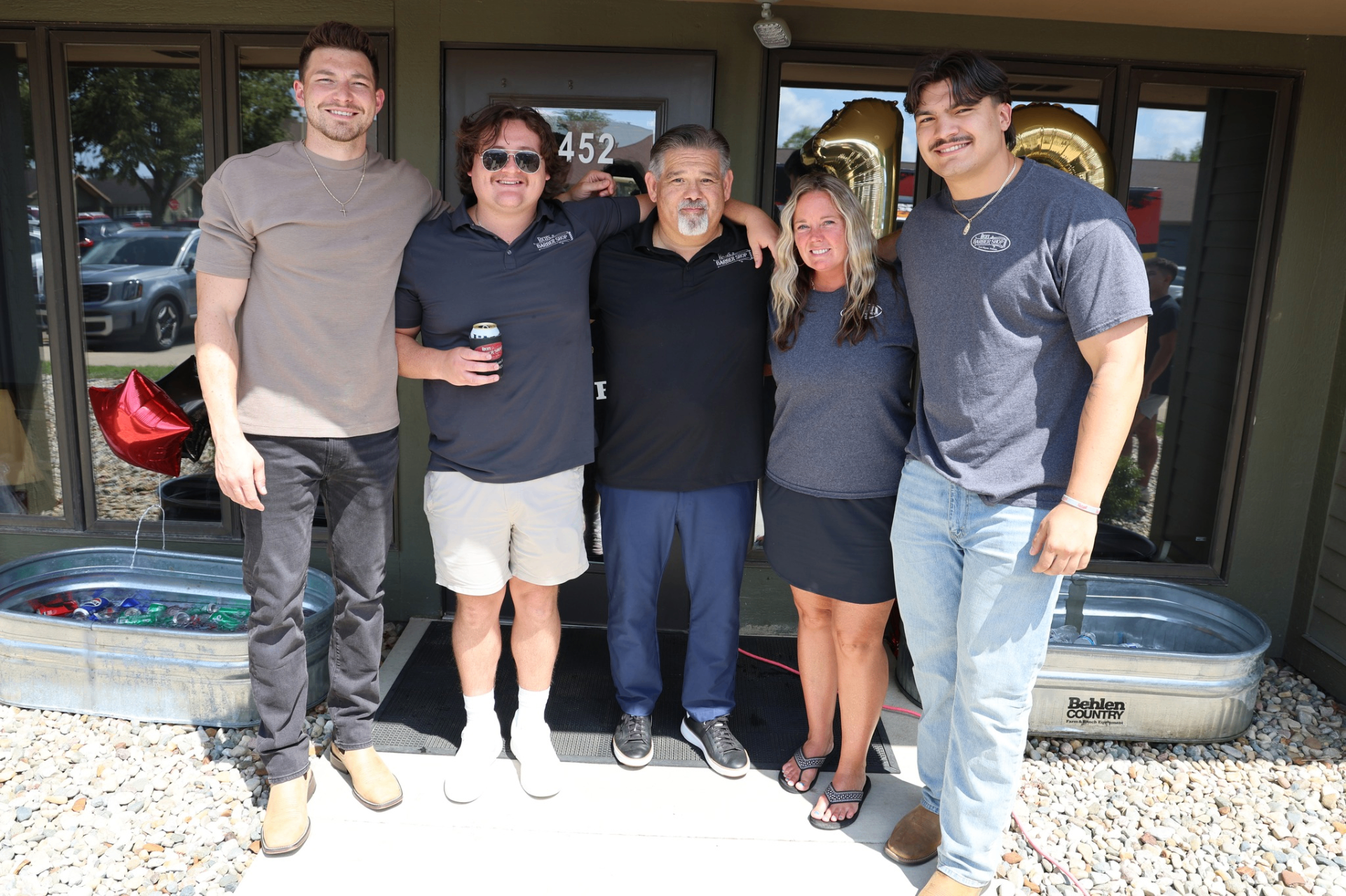 Rico's Barbershop team outside the shop